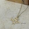 Yellow gold Am Yisrael Chai necklace on textured paper