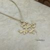 Solid gold Am Yisrael Chai Hebrew pendant on a pale ground