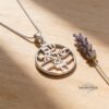 White gold Am Yisrael Chai pendant on wood with lavender