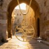 14K gold Am Yisrael Chai necklace photographed in the Old City of Jerusalem