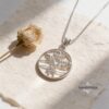 White gold Am Yisrael Chai pendant on stone with a dried rose