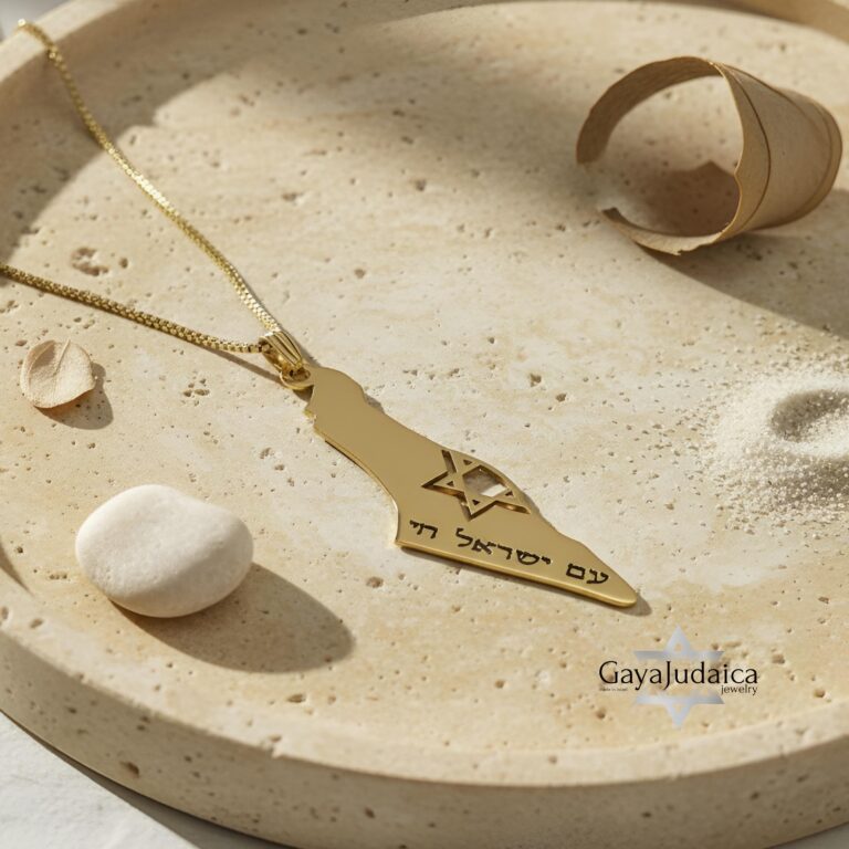14K gold Israel map necklace with Star of David resting in a stone dish