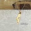 Gold Israel map necklace on patterned stone with olive wood