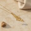 Gold Shema Israel map pendant on travertine with a pebble