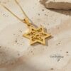 Gold Am Yisrael Chai star pendant close-up on stone