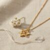Yellow gold Star of David necklace styled with dried blossom