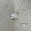 White gold Shema star pendant on textured grey paper