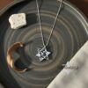White gold Shema Yisrael star necklace on a dark ceramic dish