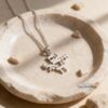Silver Am Yisrael Chai pendant on a rolo chain in a stone dish