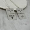 Two engraved silver dog tag pendants showing front and back