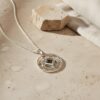 Openwork Shema Yisrael necklace on stone with a linen backdrop