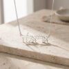 Handmade sterling silver Hebrew name necklace displayed on stone
