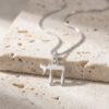 Sterling silver mini Chai pendant on a box chain, close-up