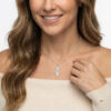 925 sterling silver engraved Israel map necklace with cut-out heart worn by a smiling woman