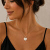 Woman wearing a 14K white gold engraved heart necklace