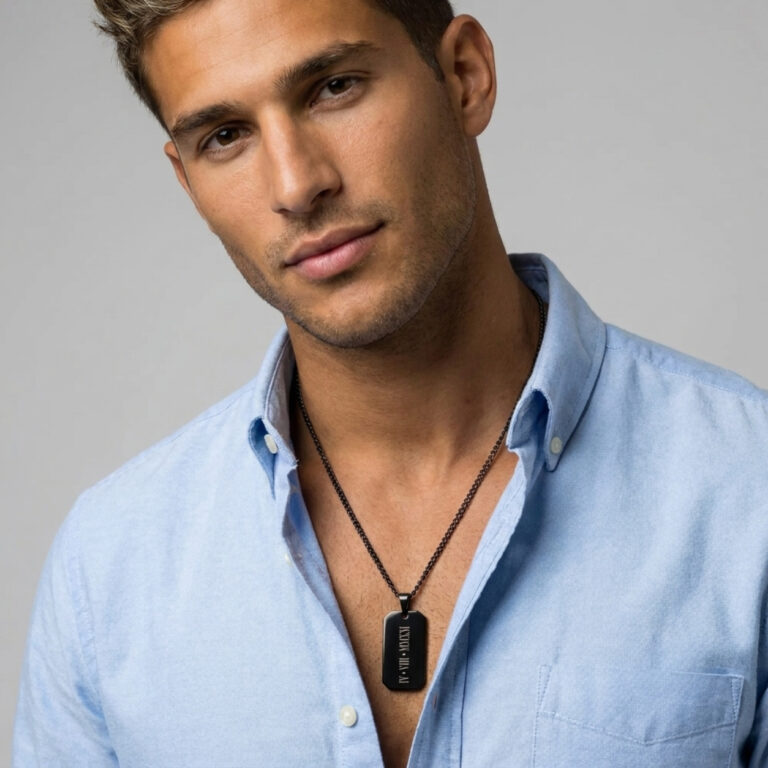 Man in a light blue shirt wearing the personalized black dog tag necklace on a curb chain