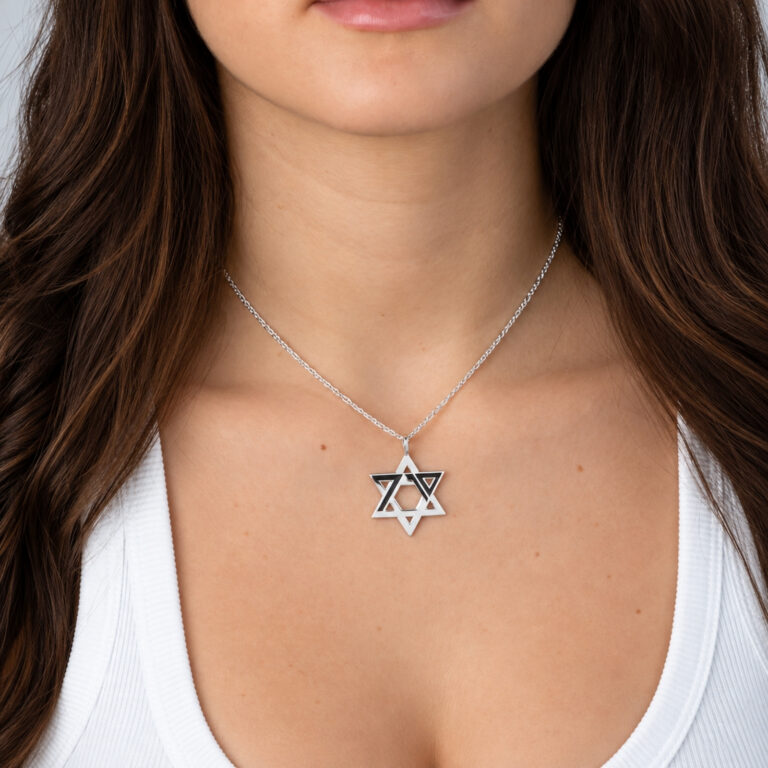 Woman wearing the sterling silver Star of David October 7 memorial necklace