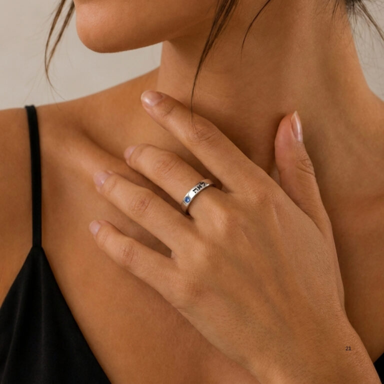 Woman wearing a sterling silver Hebrew name ring with birthstone