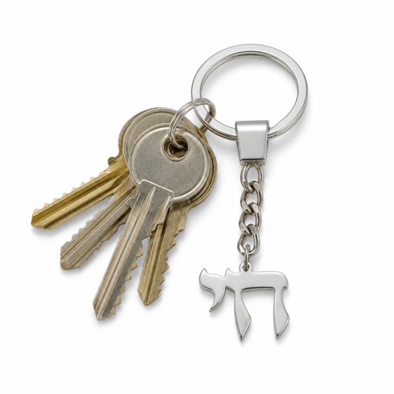 Sterling silver Chai keychain holding house keys on a white background, Jewish key ring shown in everyday use