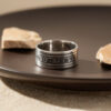 Sterling silver Psalm 91 ring on a dark plate with stones