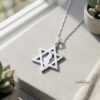 Star of David Necklace with Israel Map Cut-Out — pendant photographed by a sunlit window