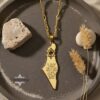 Israel Map Necklace with Hebrew Bible Verse — gold map pendant styled with dried grasses