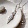 Israel Map Necklace with Engraved Bible Verse — silver map pendant on a ceramic dish
