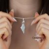 Israel Map Necklace with Engraved Bible Verse — pendant held up to show the engraved verse