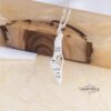 Shema Yisrael Israel Map Necklace — silver pendant resting on a wooden beam