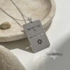 Silver Am Yisrael Chai dog tag necklace in a stone dish