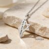 Silver Israel map and Star of David necklace in sunlight on stone