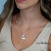 Model wearing the sterling silver October 7 Star of David pendant with a V neck top