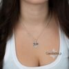 Close up of a woman wearing the sterling silver October 7 Star of David necklace