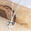 Close up of the sterling silver October 7 Star of David pendant on a rolo chain