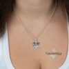 Woman wearing the October 7 memorial Star of David pendant in sterling silver on a fine chain
