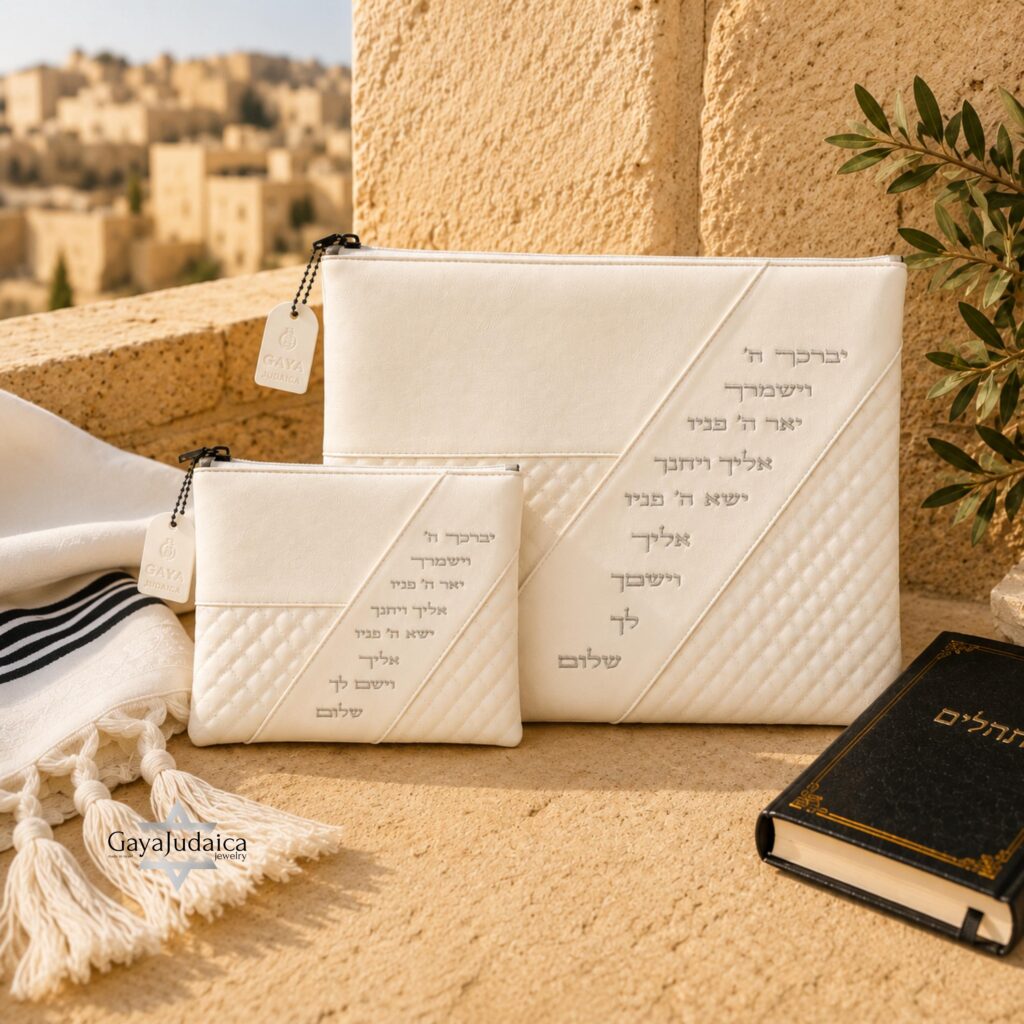 White quilted tallit and tefillin bag set embossed with the Priestly Blessing, with a prayer book and tallit in Jerusalem stone setting