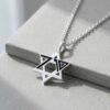 Sterling silver October 7 Star of David pendant resting on a grey stone block