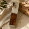 White epoxy olive wood mezuzah case on stone with olive branches