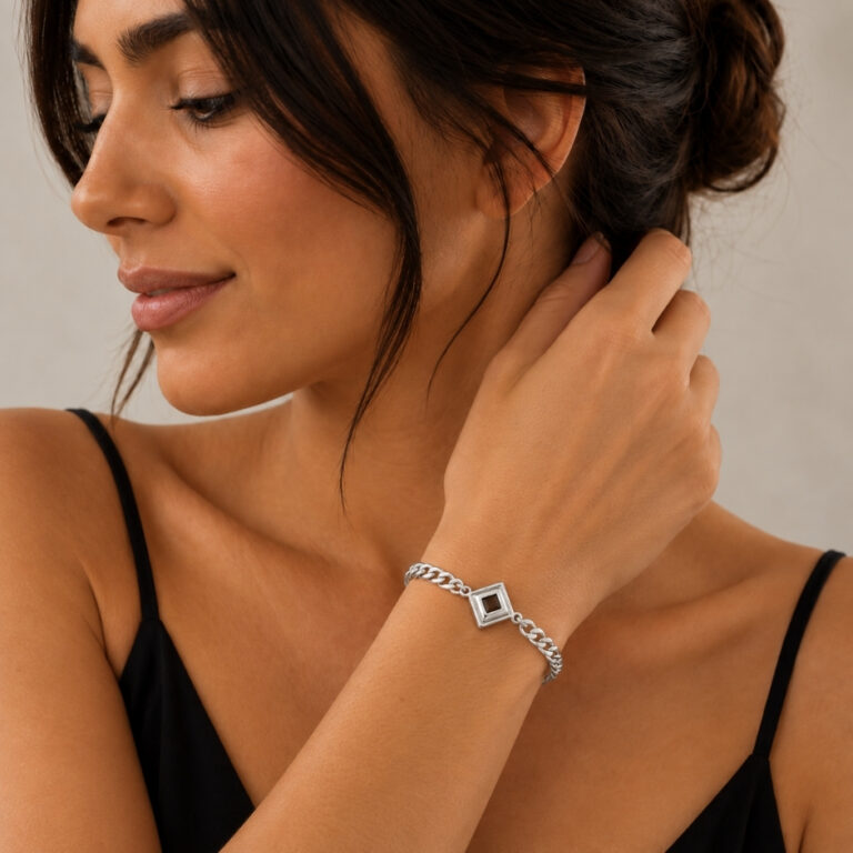 Woman wearing the sterling silver Nano Bible Bracelet, square Hebrew Tanakh pendant on a Cuban link chain styled with a black top