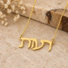 Solid gold Hebrew name necklace hanging over stone with dried flowers and olive wood in the background.