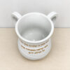 Top view inside the white Netilat Yadayim washing cup showing the wide opening, both handles and the gold Hebrew blessing
