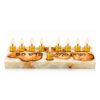 White epoxy olive wood Hanukkah menorah with lit glass oil cups and the shamash set apart in front, on white background