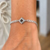 Nano Bible Bracelet worn on the wrist, square sterling silver Hebrew Tanakh pendant on a 4.4mm Cuban link chain, unisex Jewish jewelry