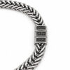 Detail of engraved Hebrew kids names on the beads of a men's stainless steel wheat chain bracelet