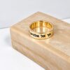 14K gold band engraved with custom Hebrew text on a stone block